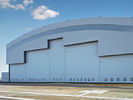 China Prefab Curve Roofing System Steel Aircraft Hangars With Electrical Slide Doors factory